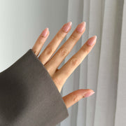 Hand with a dark sleeve with press on nails 