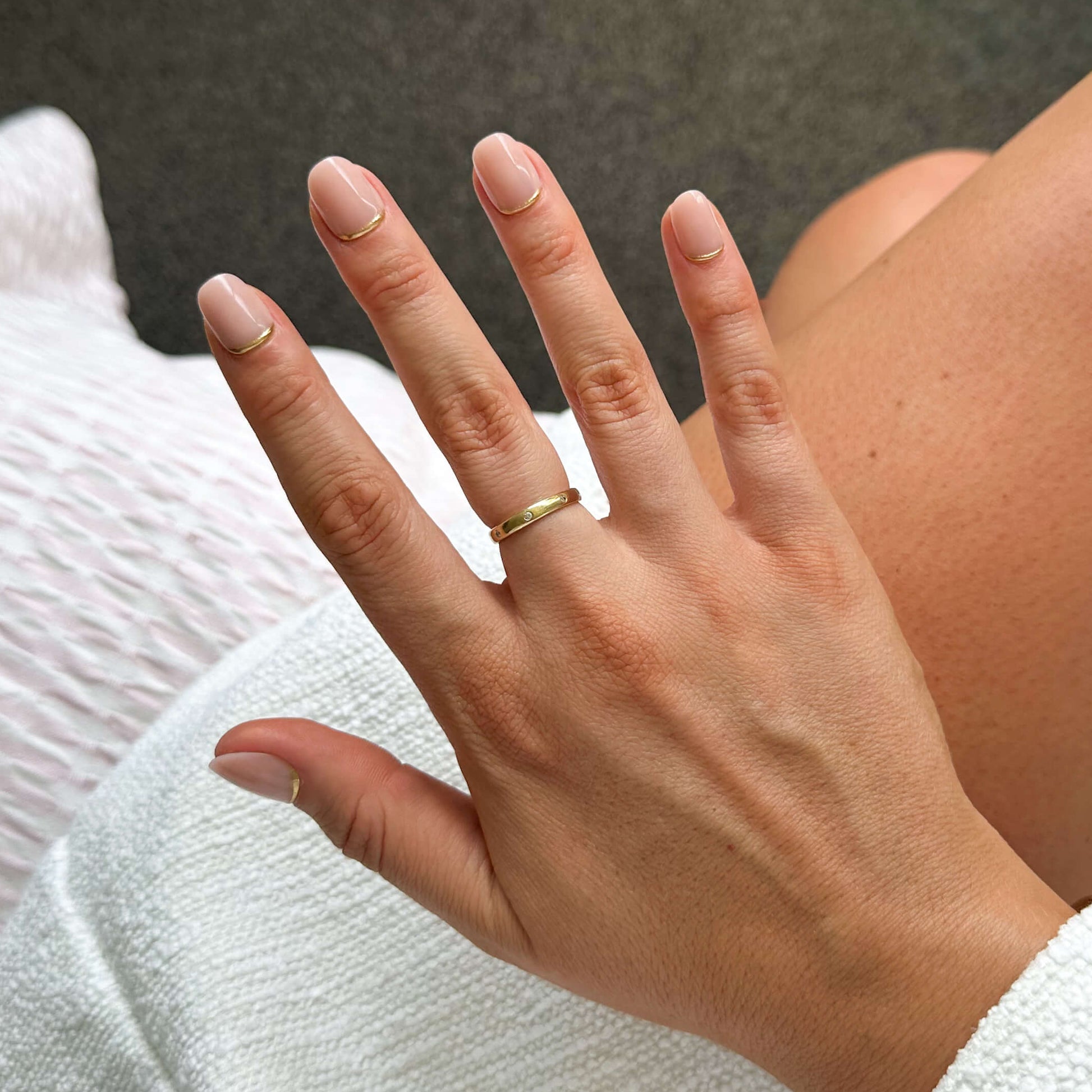 Hand with a ring on a blurred background