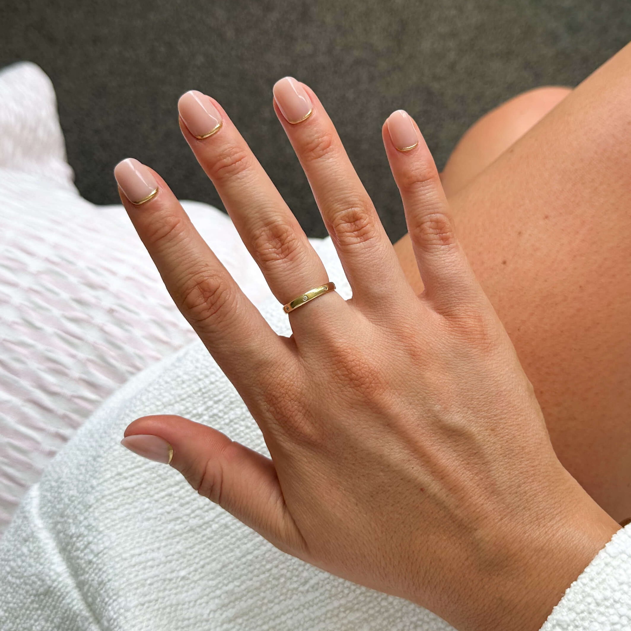 Hand with a ring on a blurred background