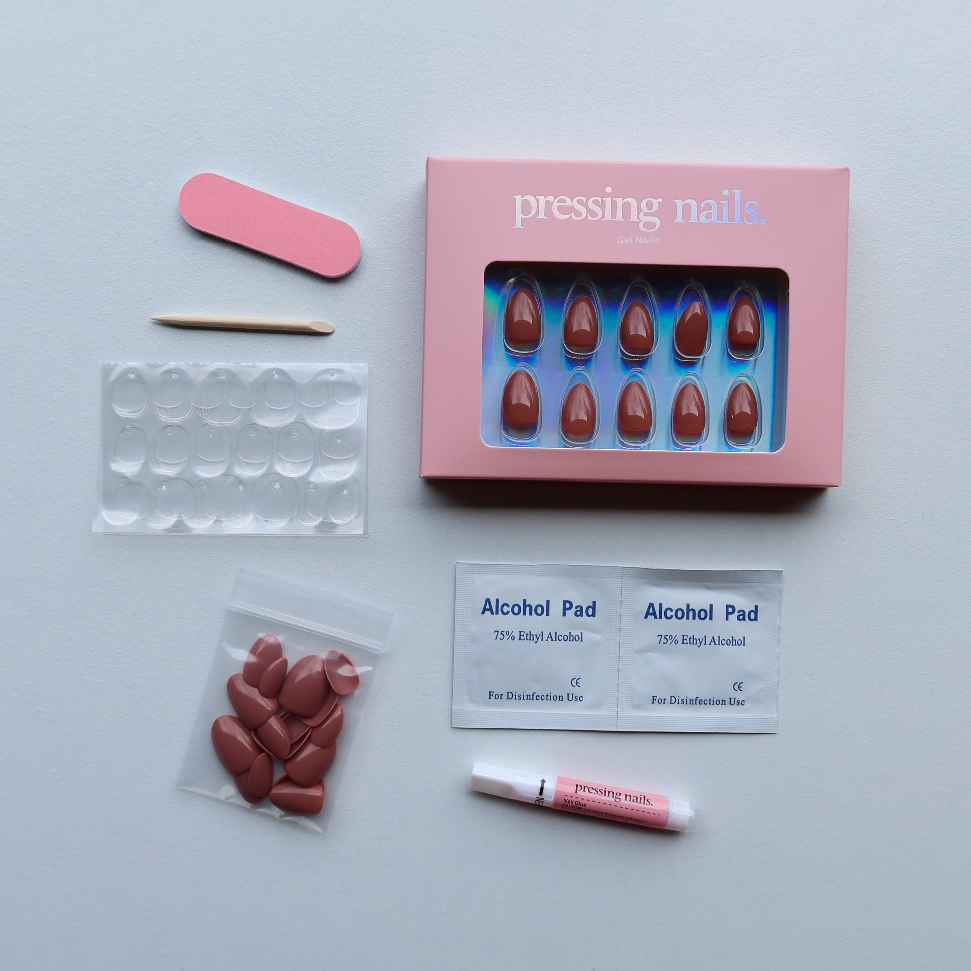 Press on Nail care kit with nail files, alcohol pads, and nail glue, on a white background
