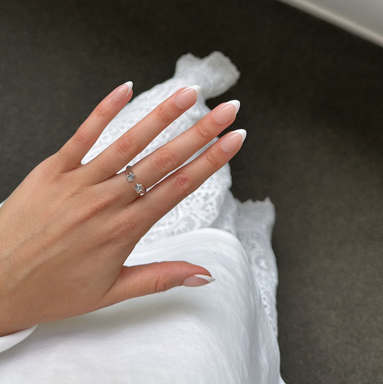 Hand with white tip press on nails 