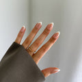 Hand wearing press on nails 